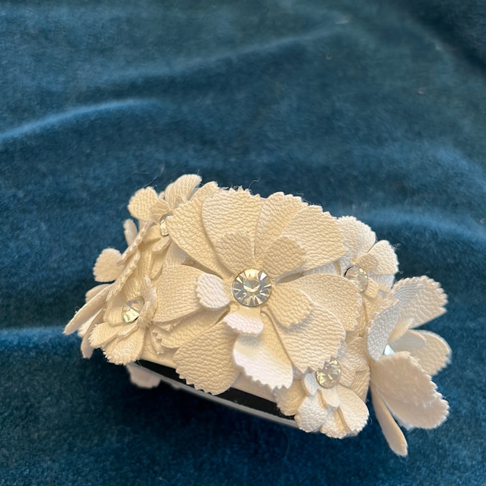 Leather cuff with intricate leather floral details.